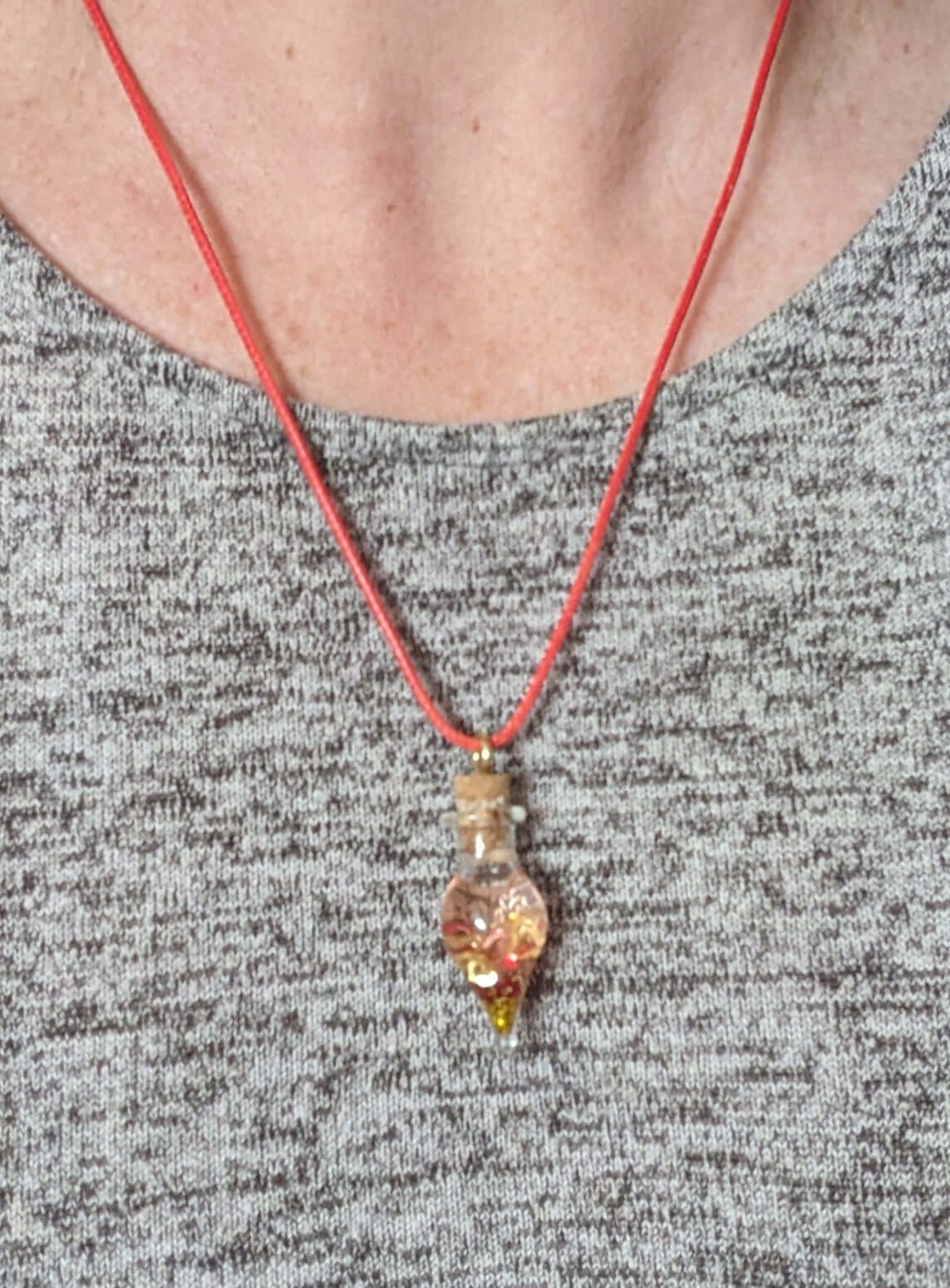 tear drop necklace with gold glitter and heart shapes