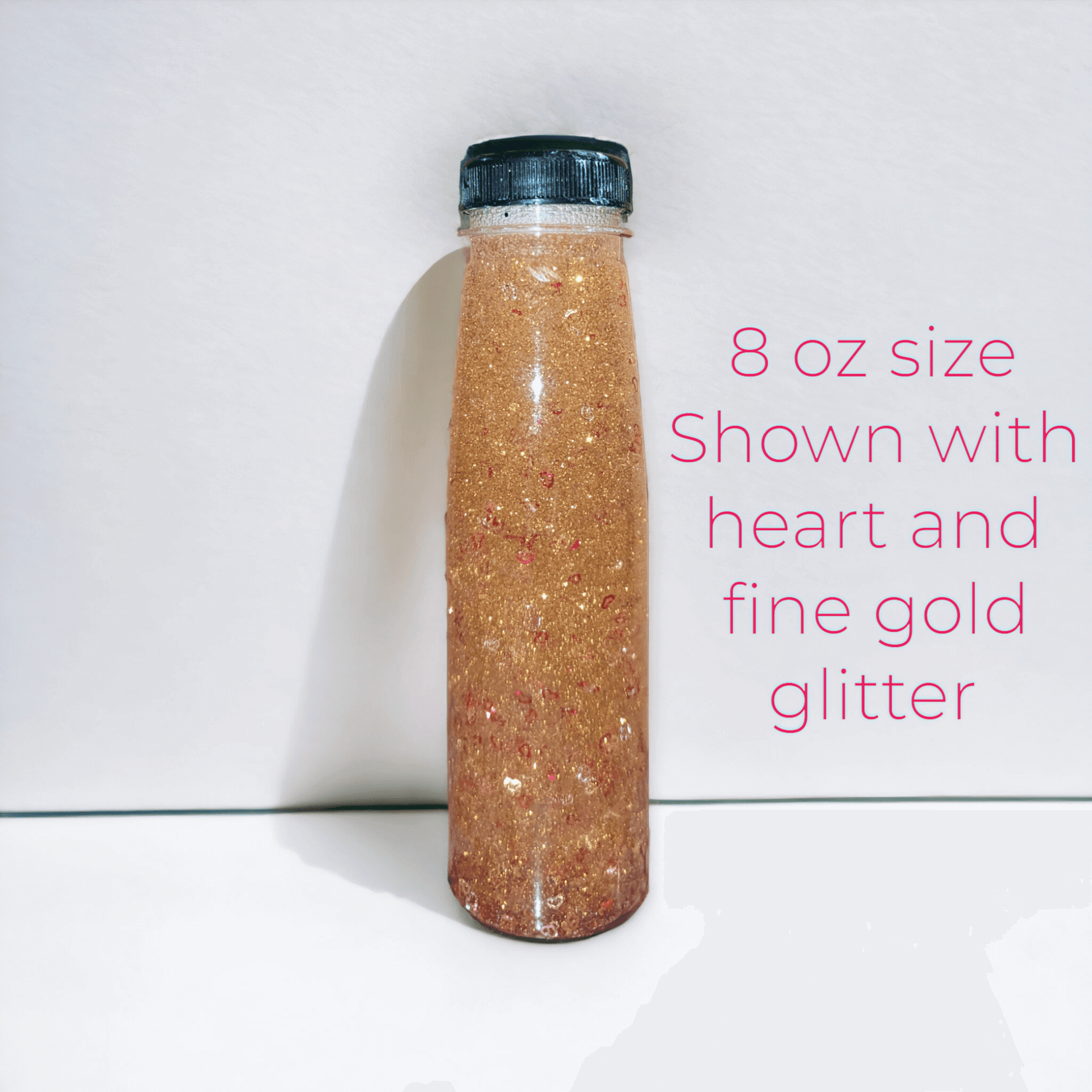 9 oz glitter bottle with gold glitter and heart shapes